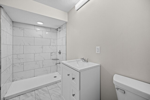 10431 Southerwick Pl, Johnston, IA 50131 - bathroom featuring a textured ceiling, marble finish floor, toilet, vanity, and a stall shower
