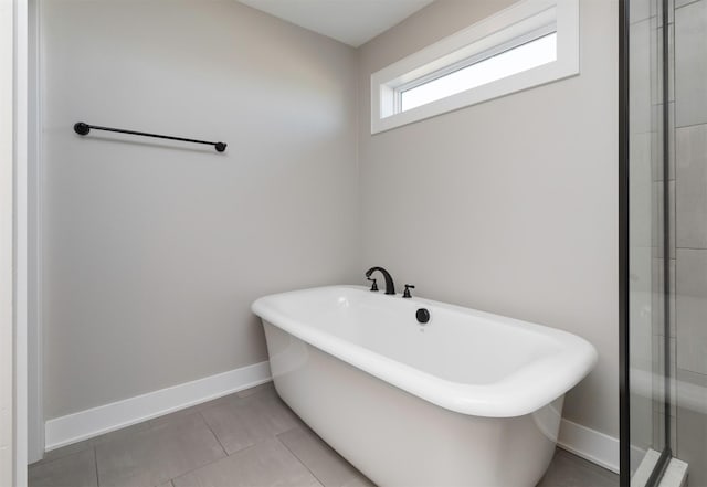 bathroom featuring a washtub and tile patterned flooring