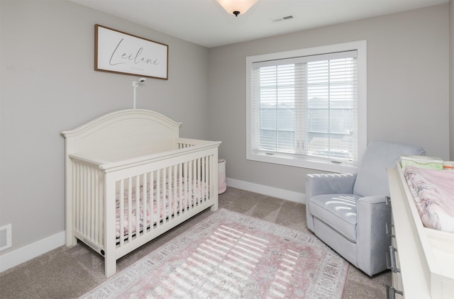 carpeted bedroom with a crib