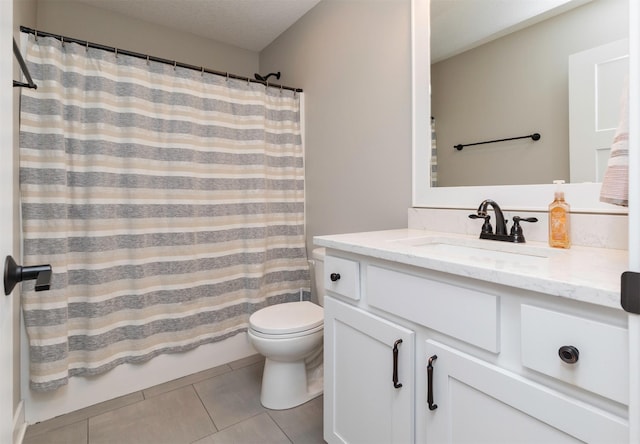 full bathroom with shower / tub combo, tile patterned flooring, vanity, a textured ceiling, and toilet