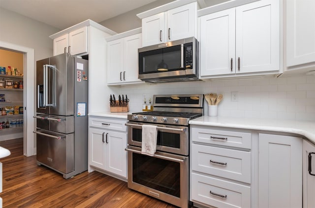 kitchen with backsplash, stainless steel appliances, dark hardwood / wood-style floors, and white cabinets