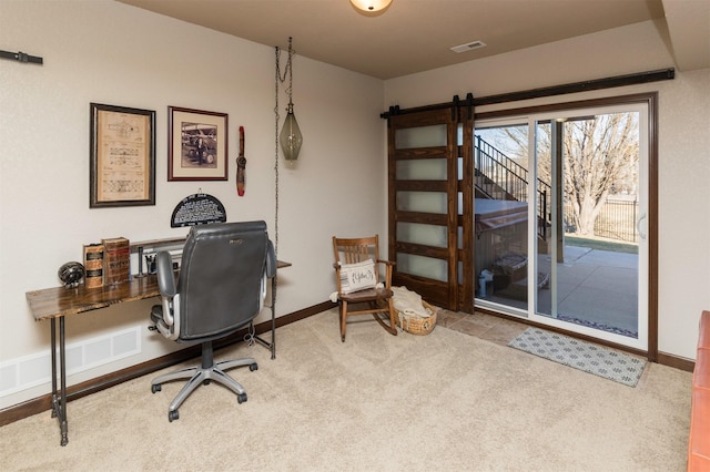 carpeted office space featuring a barn door