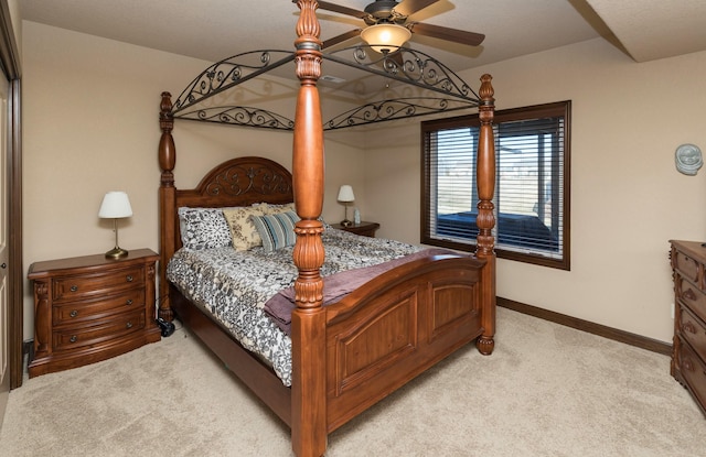 bedroom with ceiling fan and light colored carpet