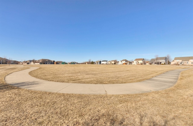 view of home's community with a yard