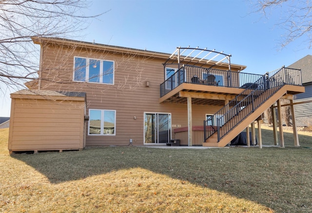 rear view of house with a wooden deck, a hot tub, and a lawn