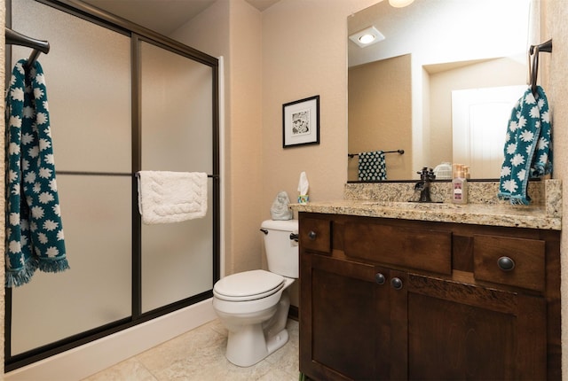 bathroom featuring vanity, an enclosed shower, and toilet