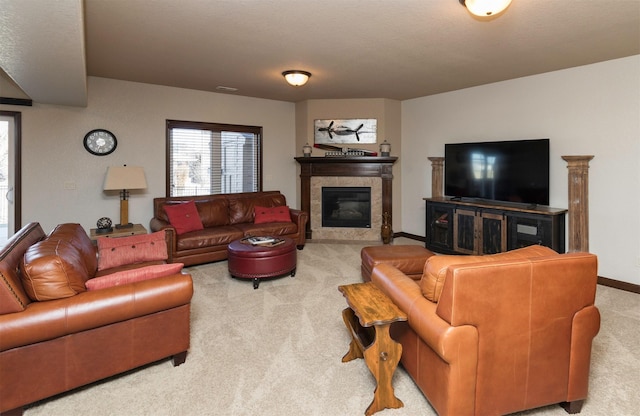 living room with a tiled fireplace and light carpet