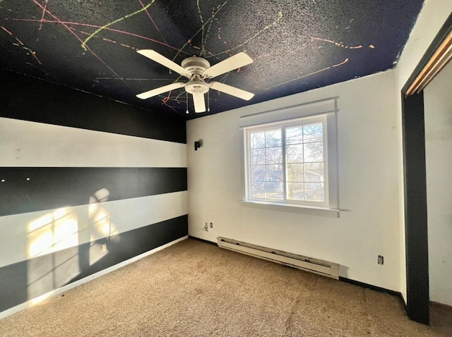 unfurnished room with baseboard heating, ceiling fan, and carpet