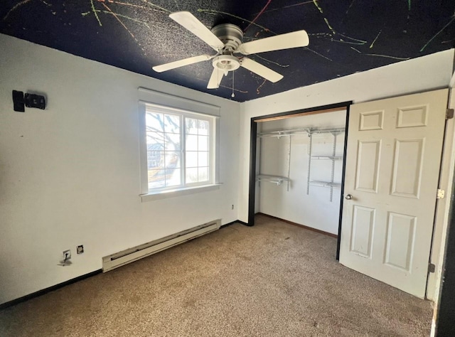 unfurnished bedroom featuring a baseboard heating unit, a closet, ceiling fan, and carpet flooring