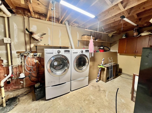 washroom with washing machine and clothes dryer