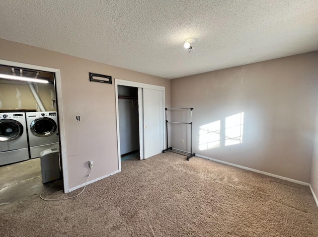 unfurnished bedroom featuring washing machine and dryer, a closet, a textured ceiling, and carpet flooring