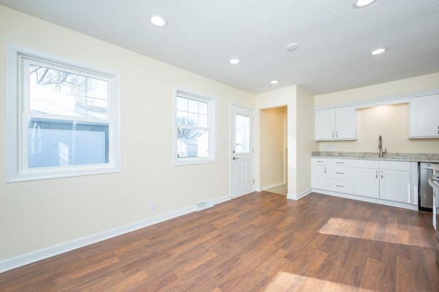 kitchen with sink, dark wood-type flooring, white cabinets, and plenty of natural light