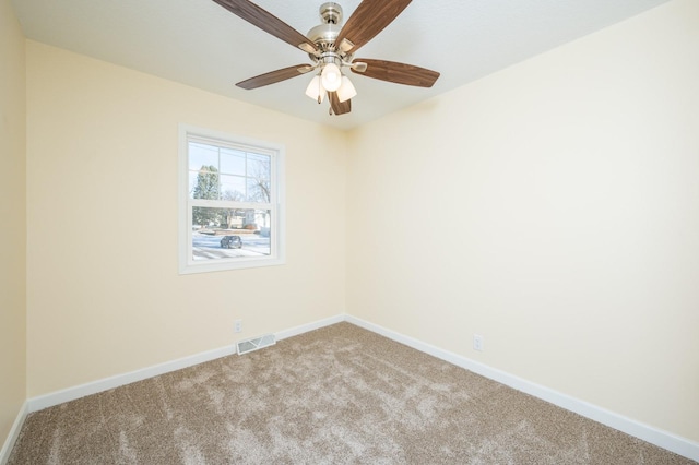 spare room featuring ceiling fan and carpet flooring