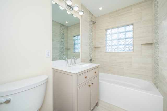 full bathroom featuring vanity, tiled shower / bath combo, and toilet