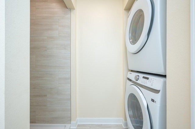 laundry area featuring stacked washing maching and dryer