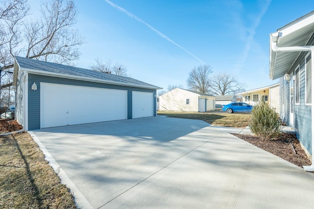 view of property exterior with a garage and an outbuilding