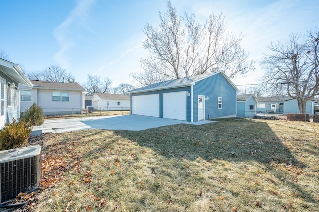 garage with cooling unit and a lawn