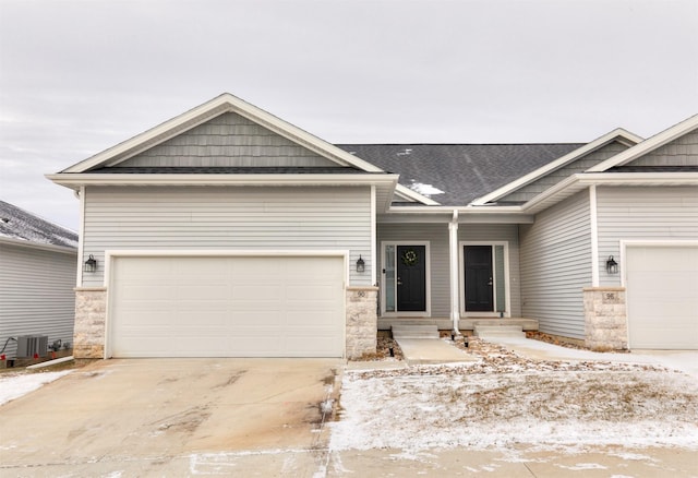 craftsman house with a garage and central AC