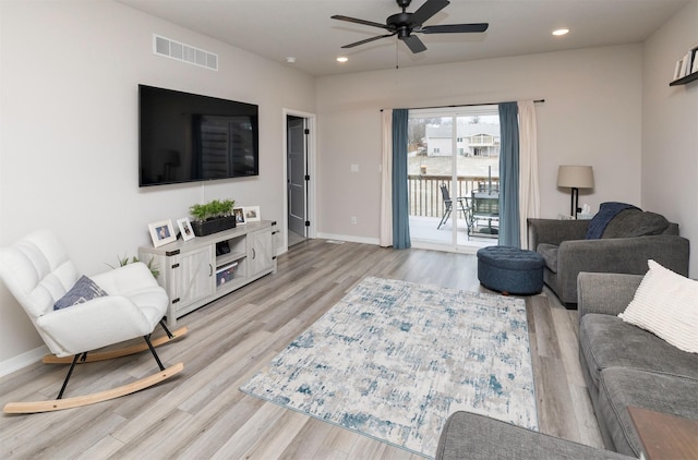 living room with ceiling fan and light hardwood / wood-style floors