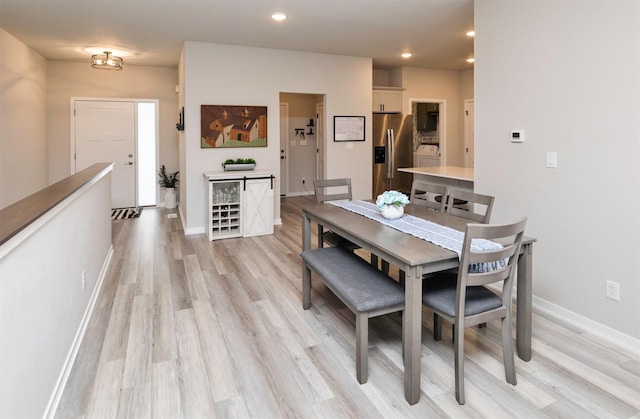 dining space featuring washer / dryer and light hardwood / wood-style floors