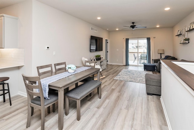 dining room with ceiling fan and light wood-type flooring