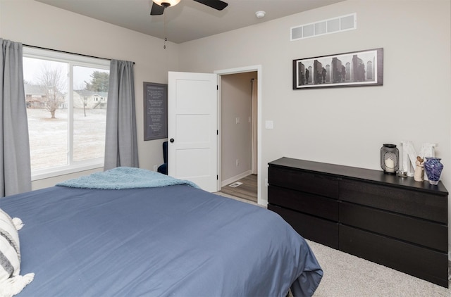 bedroom with multiple windows and ceiling fan