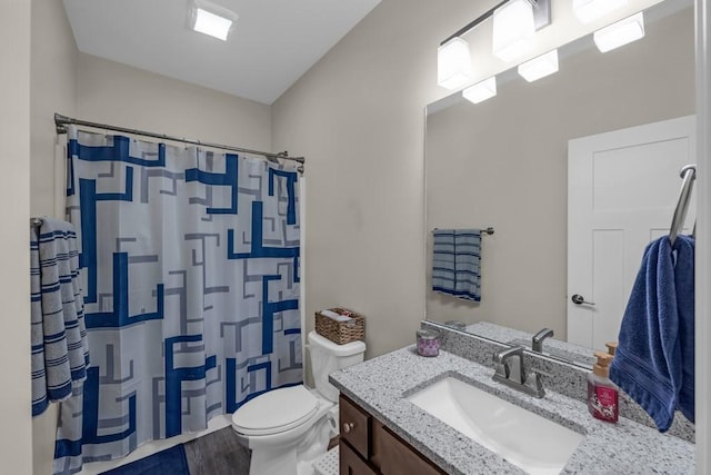 bathroom featuring vanity, hardwood / wood-style floors, a shower with curtain, and toilet