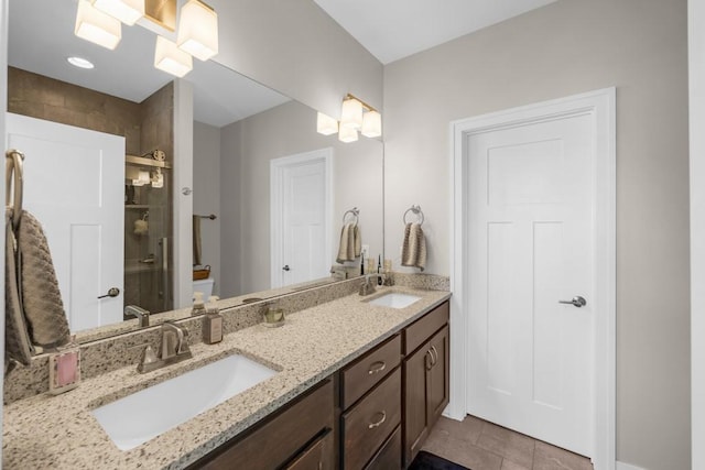 bathroom featuring an enclosed shower, vanity, and tile patterned flooring