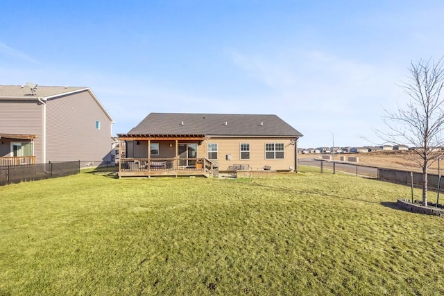 back of property featuring a wooden deck and a yard