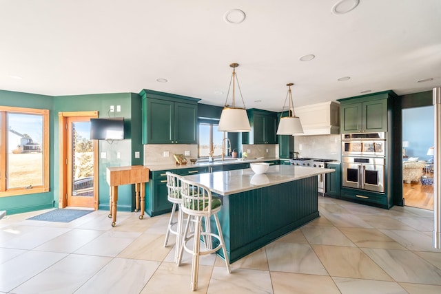 kitchen featuring decorative backsplash, green cabinets, stainless steel double oven, and light countertops