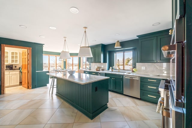 kitchen featuring backsplash, green cabinets, stainless steel dishwasher, a sink, and fridge