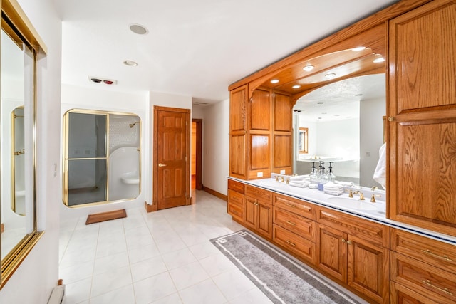 bathroom with recessed lighting, a stall shower, tile patterned flooring, and vanity