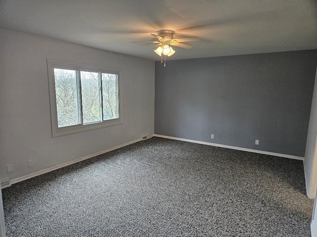 unfurnished room with ceiling fan and carpet