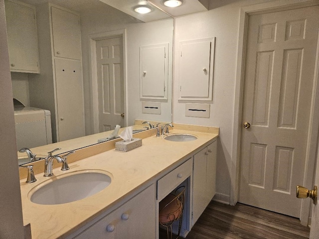 bathroom with hardwood / wood-style flooring, vanity, washer / dryer, and toilet