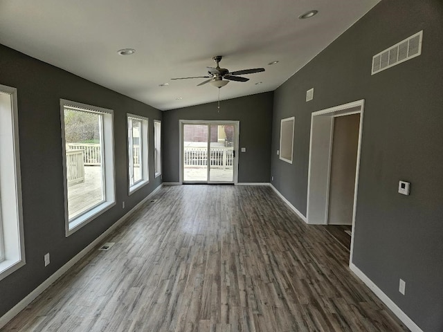 interior space featuring ceiling fan, dark hardwood / wood-style floors, and vaulted ceiling