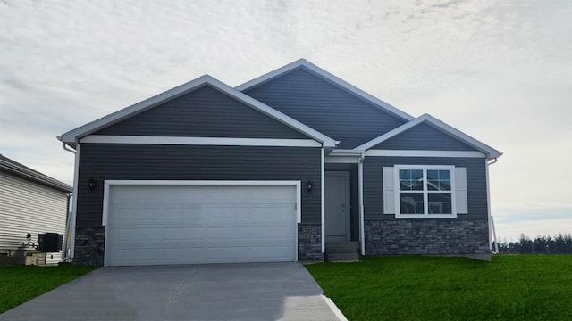 craftsman inspired home with a garage and a front lawn