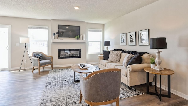 living room with hardwood / wood-style flooring and a textured ceiling