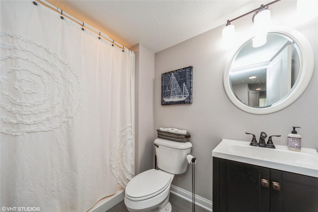 bathroom featuring vanity, hardwood / wood-style flooring, toilet, and a textured ceiling