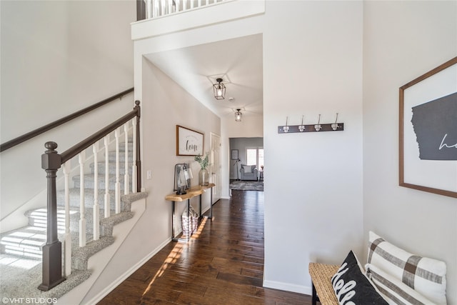 interior space with vaulted ceiling and dark hardwood / wood-style floors