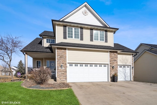 front of property with a porch, a garage, and a front lawn