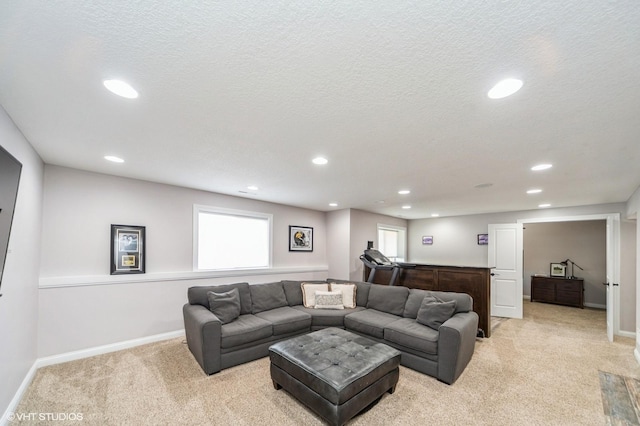 living room featuring light carpet and a textured ceiling