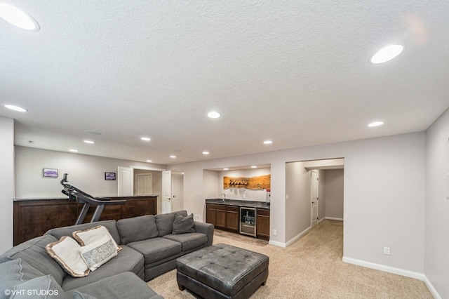 carpeted living room with indoor bar, beverage cooler, and a textured ceiling