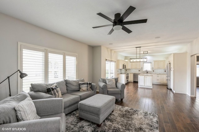 living area featuring a ceiling fan and dark wood finished floors