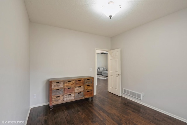 bedroom featuring visible vents, baseboards, and dark wood finished floors