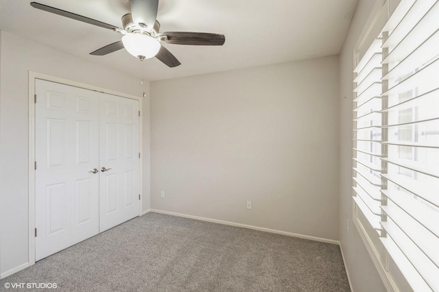unfurnished bedroom with a closet, ceiling fan, baseboards, and carpet floors