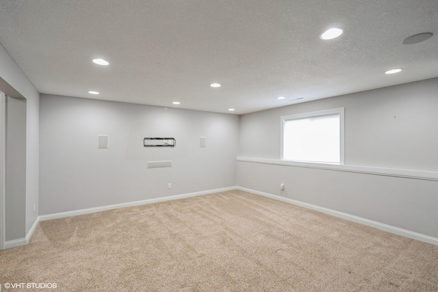basement with a textured ceiling, recessed lighting, baseboards, and carpet floors