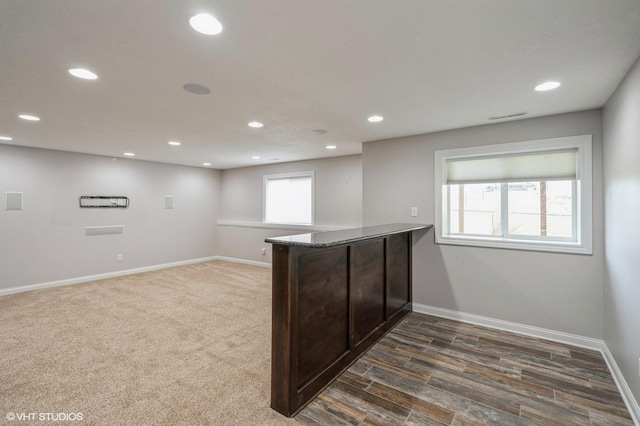 kitchen featuring dark carpet, a peninsula, visible vents, recessed lighting, and baseboards