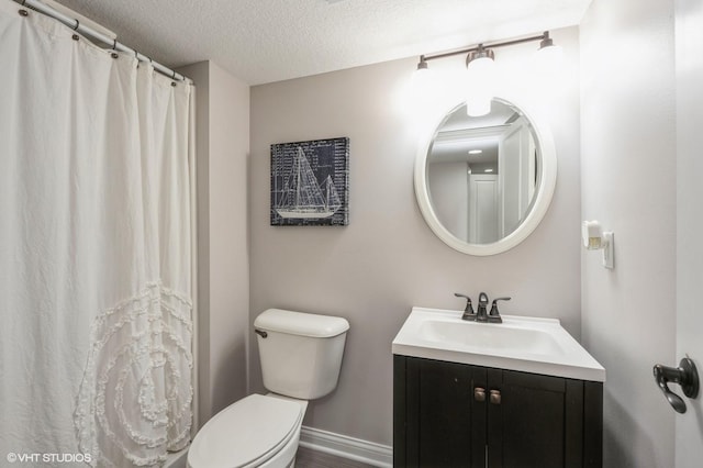 bathroom featuring a shower with shower curtain, vanity, baseboards, a textured ceiling, and toilet