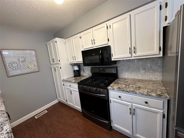 kitchen with light stone counters, white cabinets, and black appliances