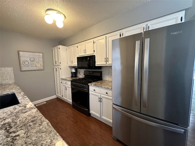 kitchen featuring white cabinetry, backsplash, dark hardwood / wood-style floors, light stone countertops, and black appliances